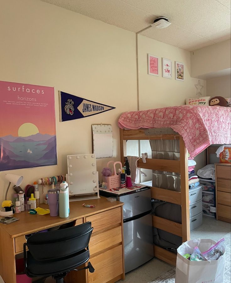 a dorm room with bunk beds and desk