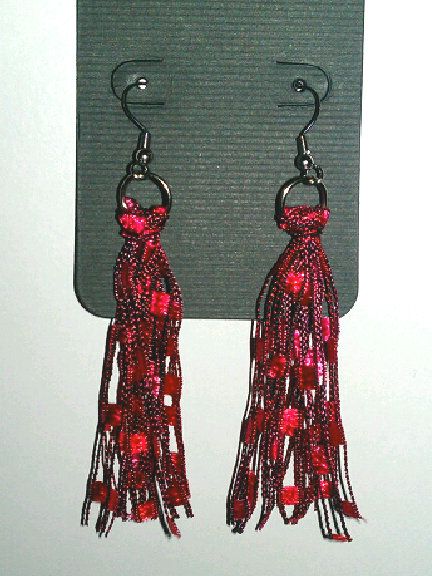 pair of red beaded tassels hanging from hook earring hooks on white background