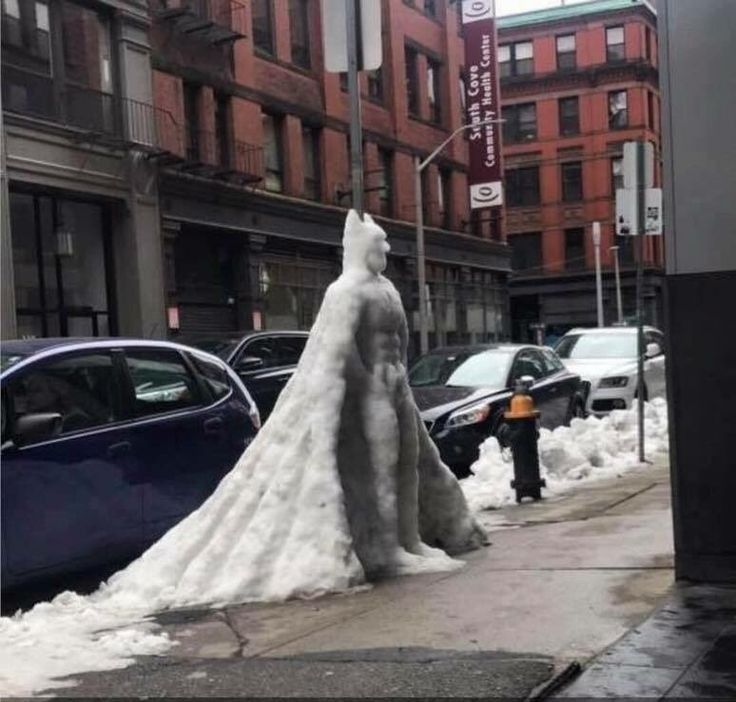 there is a snow sculpture on the sidewalk