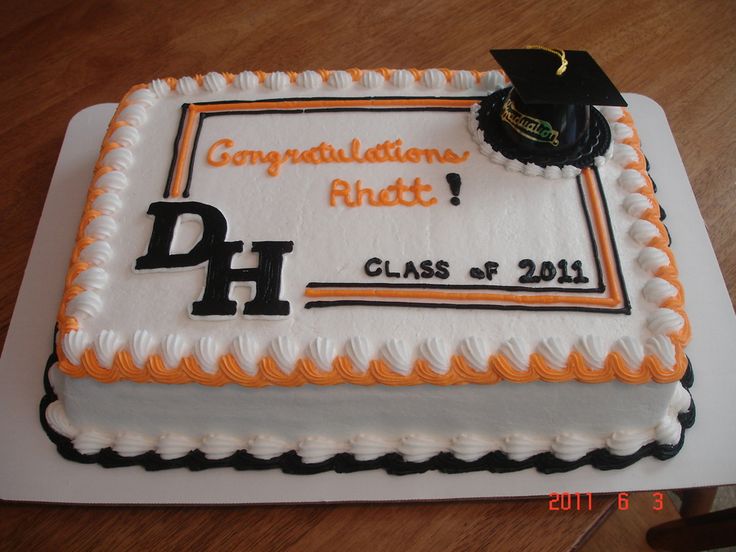 a cake that is on top of a white plate with black and orange trims