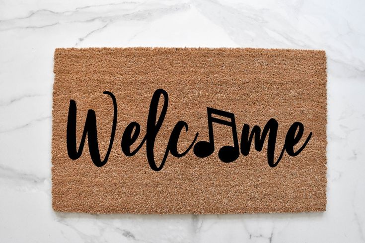 a welcome mat with the word welcome on it and a heart in the center that says'welcome '