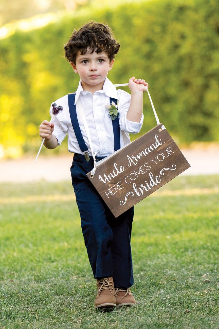 a little boy holding a sign that says we are married