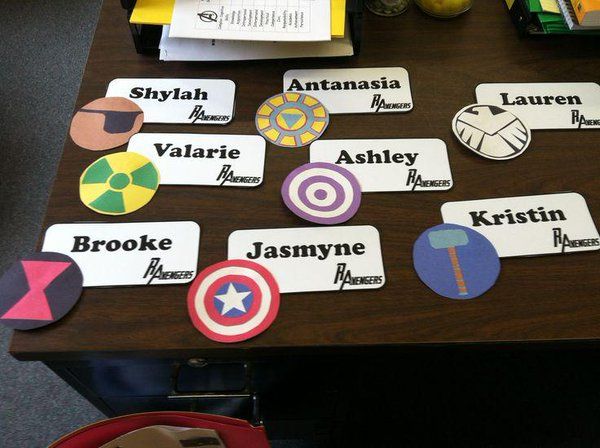 a table topped with lots of stickers on top of a wooden table next to a red chair