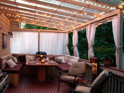 a covered patio with lots of furniture and string lights