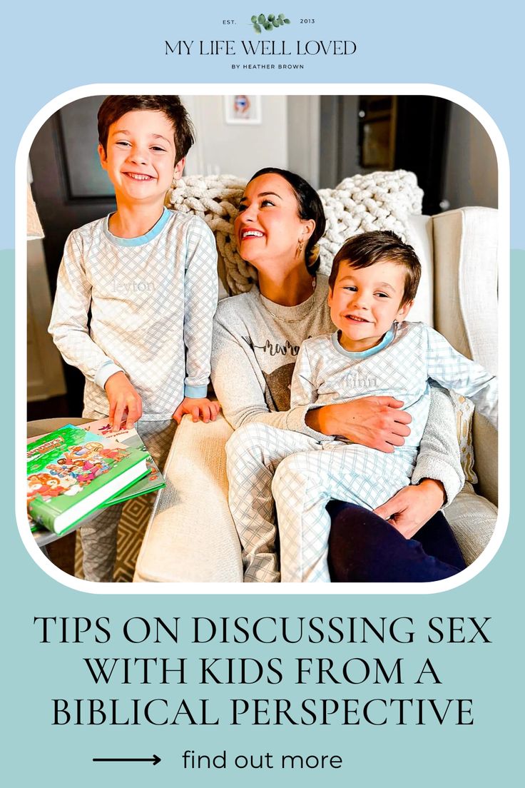 a woman and two children sitting on a chair with a book in front of them