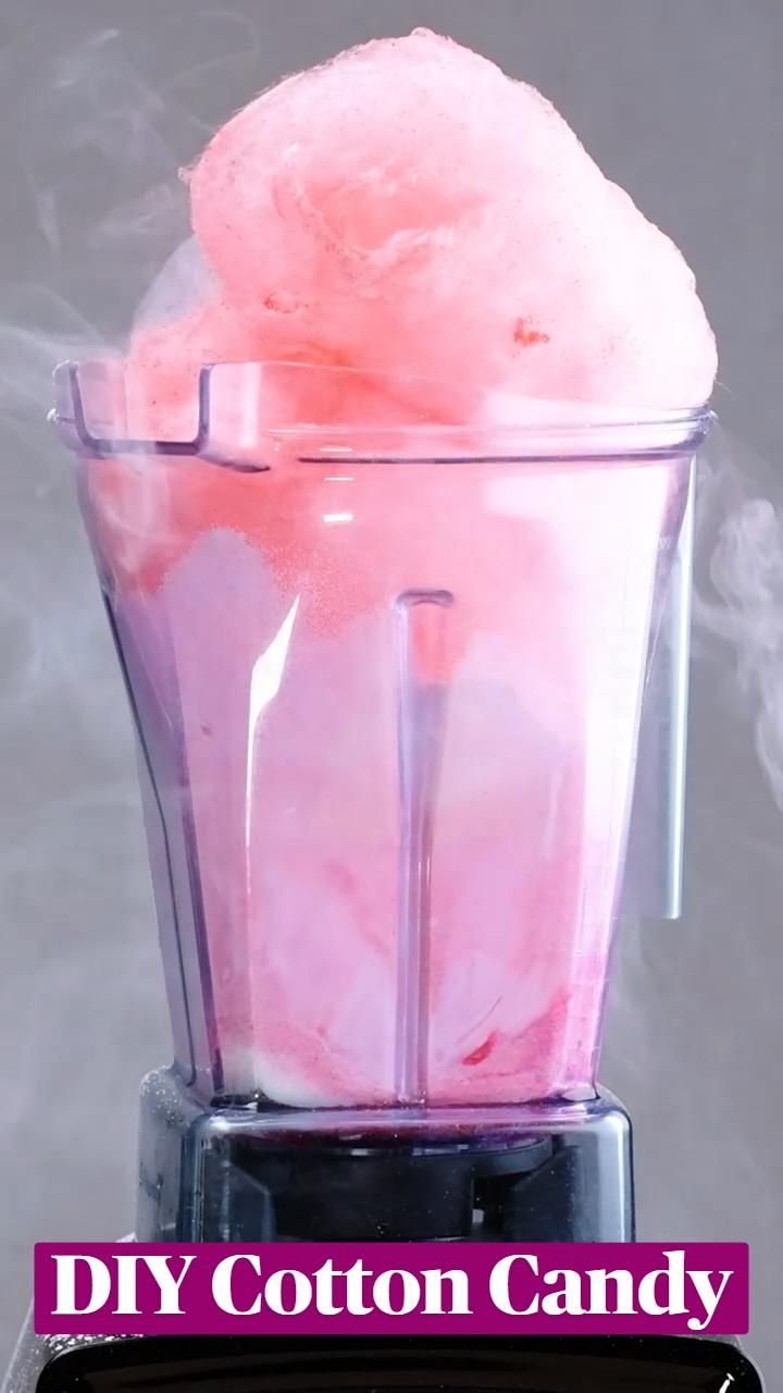 a blender filled with pink cotton candy sitting on top of a counter next to the words diy cotton candy