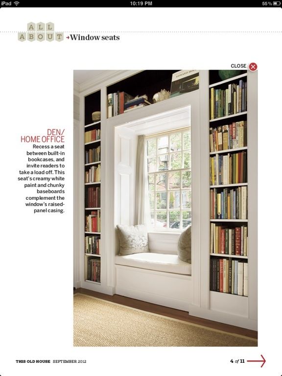 an image of a window seat in front of a bookshelf filled with books