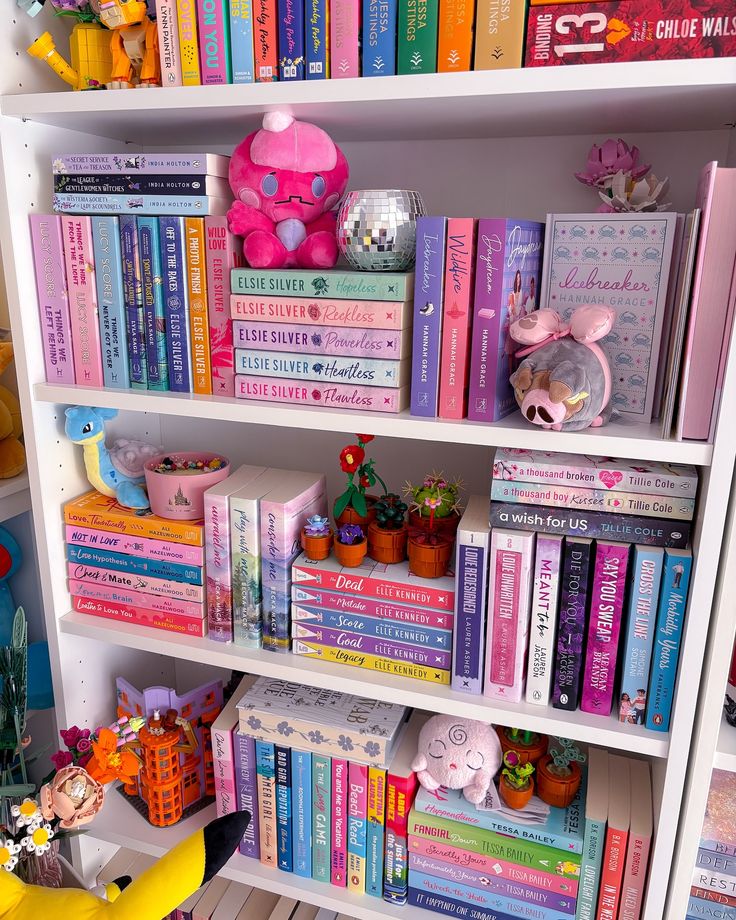 a book shelf filled with lots of books and stuffed animals on top of each shelf