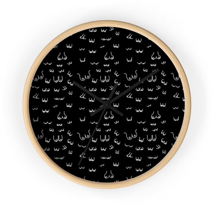 a clock with black and white designs on the face, which is surrounded by smaller letters