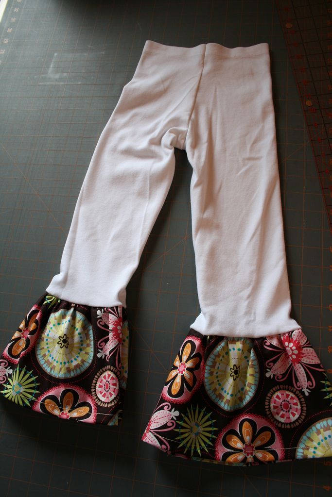 a pair of white leggings sitting on top of a cutting board