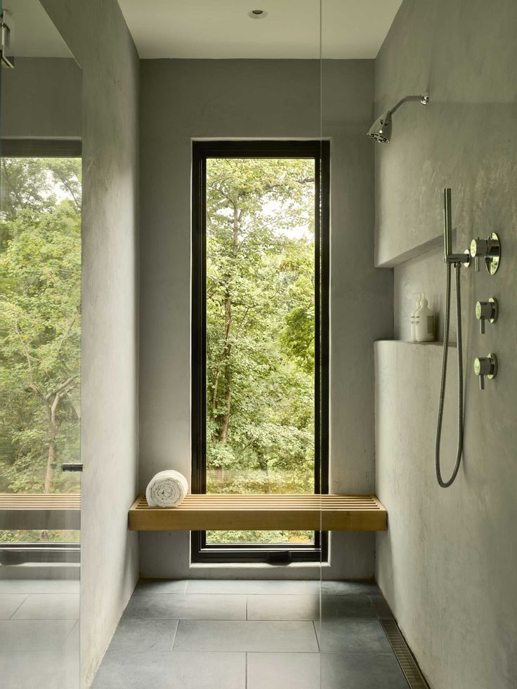 A modern bathroom with a window in the shower that frames the forest view. Home In The Forest, Robert Young, Window In Shower, Glass Stairs, Steel Stairs, Storey Homes, Bathroom Windows, Bath Ideas, Garden Windows