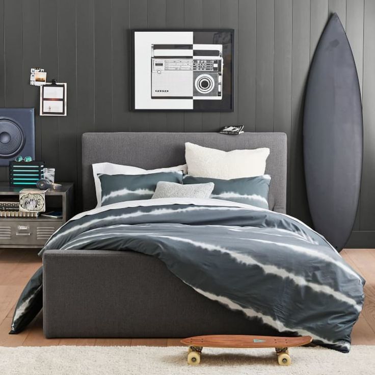 a bed with a skateboard on top of it in a room next to a wall