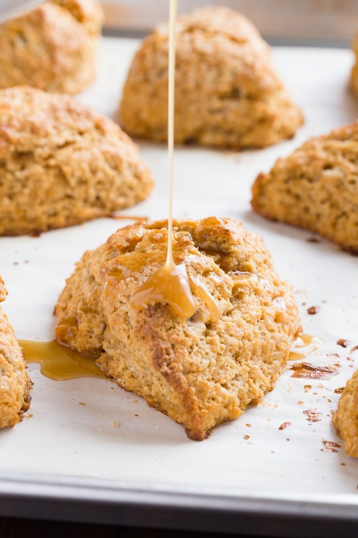 honey citrus sweet potato scones are being drizzled with caramel sauce