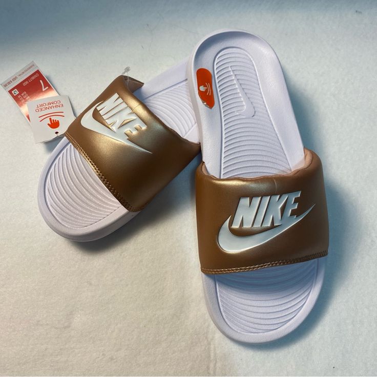 Victori One Slides White With Muted Gold Strap Ynf 13204, 13261 (7) Ynf 12740, 12843 (8) Ynf 12738 (9) Gold Casual Slip-on Slides, Sporty Brown Slides For Summer, Casual Gold Slides For Spring, Casual Gold Synthetic Slides, Nike Low-top Slides For Summer, Nike Sporty Slides For Spring, Nike Presto Women, Nike Flip Flops, Casual Logo