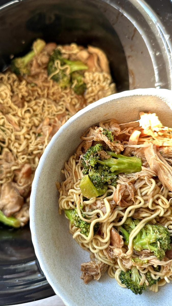 a white bowl filled with noodles and broccoli