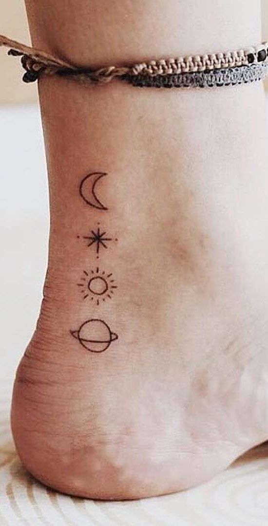 a woman's foot with three small tattoos on it