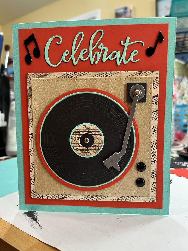 a handmade card with a record player and the words celebrate written on it in cursive writing