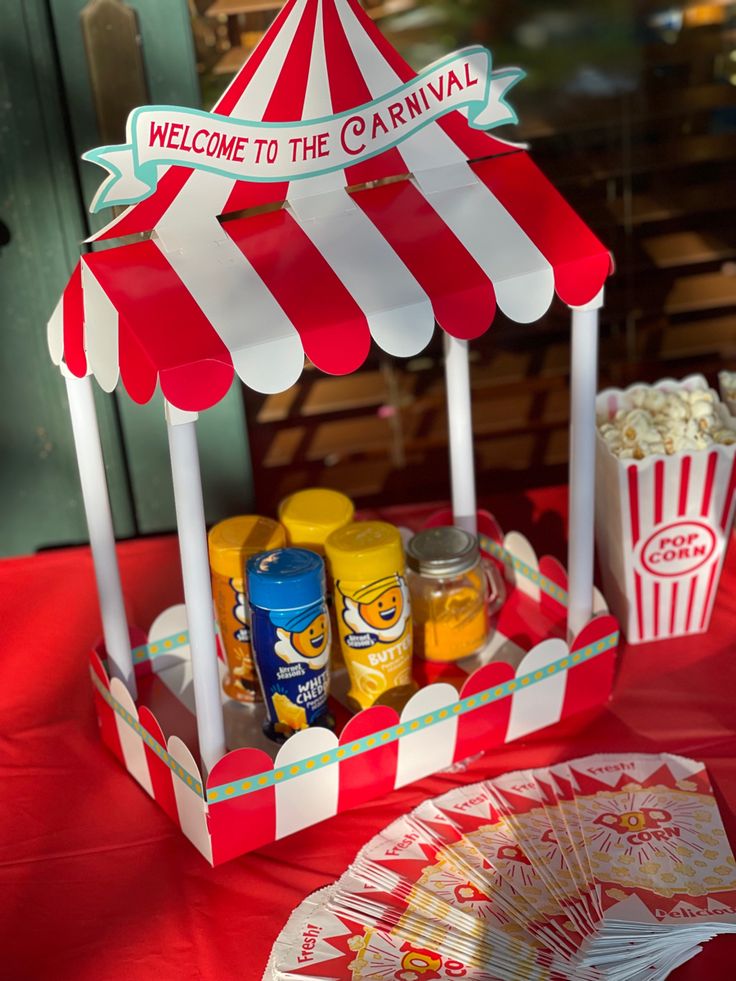 a red and white striped tent sitting next to a plate with food on top of it