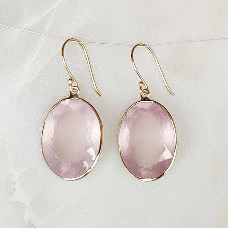 ITEM DESCRIPTION: >> The earrings are made from Solid 14K Yellow Gold. Gemstone used is absolutely natural and ethically sourced. >> Natural Rose Quartz in bezel setting is studded on it with utmost precision. >> This is a minimalist design and is absolutely hassle-free and everyday jewelry. Gem: Rose Quartz Gem size: 13x18mm Gem weight: 22.30 carats Gold purity: 14K (58.33% approx.) Gold weight: 0.87 grams Gross weight: 5.33 grams The Gold purity is guaranteed and it comes wit Formal Pink Gold Gemstone Earrings, Oval Rose Gold Sterling Silver Earrings, Elegant Pink 14k Gold Earrings, Elegant Pink Faceted Earrings, Pink Gold Gemstone Earrings In Fine Jewelry Style, Fine Jewelry Pink Gold Gemstone Earrings, Pink Gold Gemstone Earrings Fine Jewelry, Elegant Oval Faceted Earrings, Handmade Jewelry Box