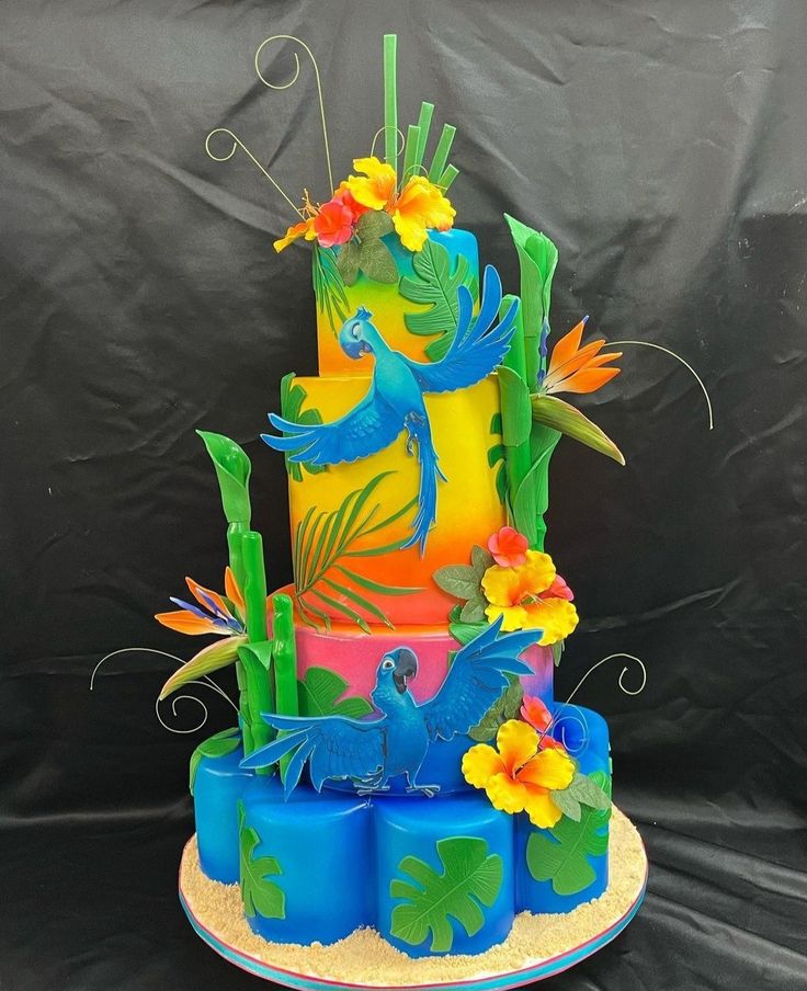 a multi layer cake decorated with flowers and birds