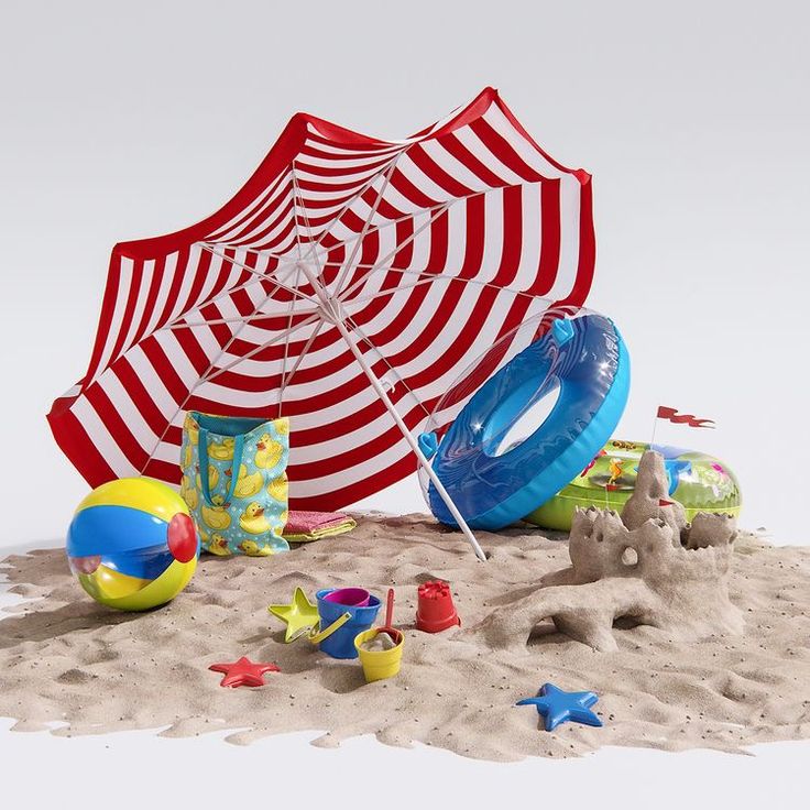 an umbrella and toys are laying on the sand in front of a beach ball, water toy, and starfish