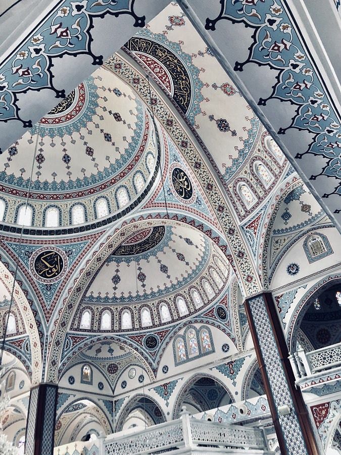 the interior of an ornate building with blue and white designs on it's walls