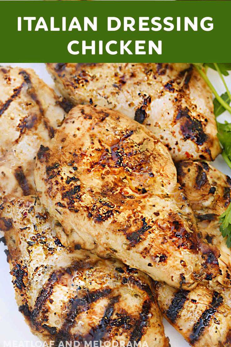 grilled chicken on a white plate with green garnish and text overlay that reads italian dressing chicken