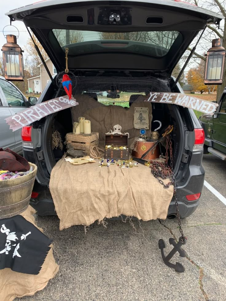 the trunk of a car is filled with pirate decorations and other items, including an umbrella