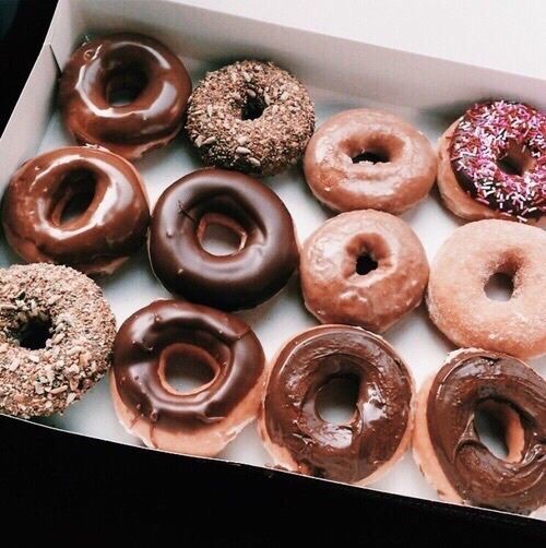 a box filled with lots of different flavored donuts