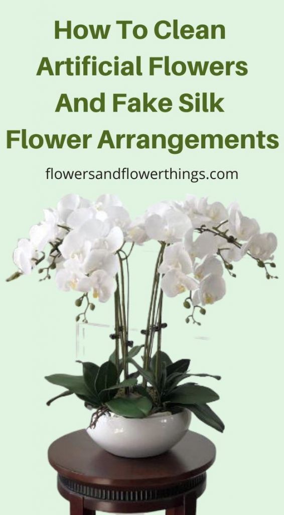 white flowers sitting on top of a table with the words how to clean artificial flowers and fake silk flower arrangements