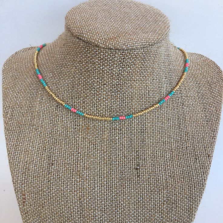 "Gold seed beads in between turquoise and salmon seed beads on a wire strand with a silver tone lobster clasp and 2\" extender" Adjustable Gold Turquoise Necklace With Colorful Beads, Adjustable Turquoise Beaded Necklaces, Adjustable Turquoise Beaded Necklace, Adjustable Gold Turquoise Beaded Necklace, Turquoise Heishi Beads Jewelry With Beaded Chain, Adjustable Beaded Multicolor Turquoise Necklace, Adjustable Turquoise Heishi Beads Necklace, Adjustable Multicolor Turquoise Necklace With Tiny Beads, Adjustable Turquoise Heishi Beaded Necklaces