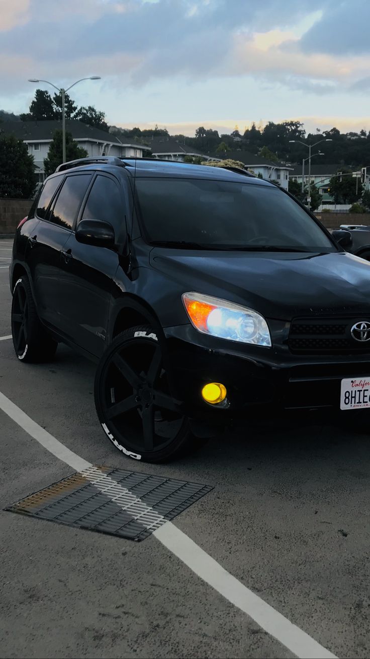 a black suv parked in a parking lot