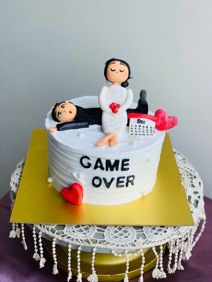 a cake that is shaped like a couple in a bathtub with the words game over on it