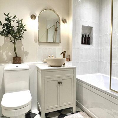 a white bathroom with black and white checkered flooring on the floor, sink, toilet and bathtub