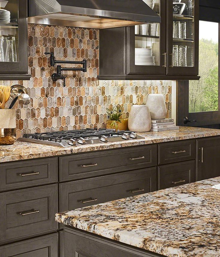 Introducing the enchanting Taos Picket Pattern Tile, a captivating mosaic that weaves together a rich tapestry of warm golds, deep browns, and serene cool grays. Crafted from crystallized glass, this backsplash tile stands as a testament to the seamless fusion of nature's hues. Its modern picket design adds a contemporary twist, offering the flexibility to be installed vertically or horizontally, allowing you to tailor the design to your exact vision. Embrace the endless possibilities of Taos Pi Brown Granite Countertops, Granite Backsplash, Countertop Backsplash, Brown Granite, Rustic Kitchen Cabinets, Kitchen Backsplash Designs, Backsplash Designs, Granite Countertops Kitchen, White Countertops