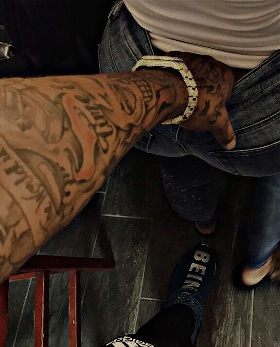 two men with tattoos on their arms and legs