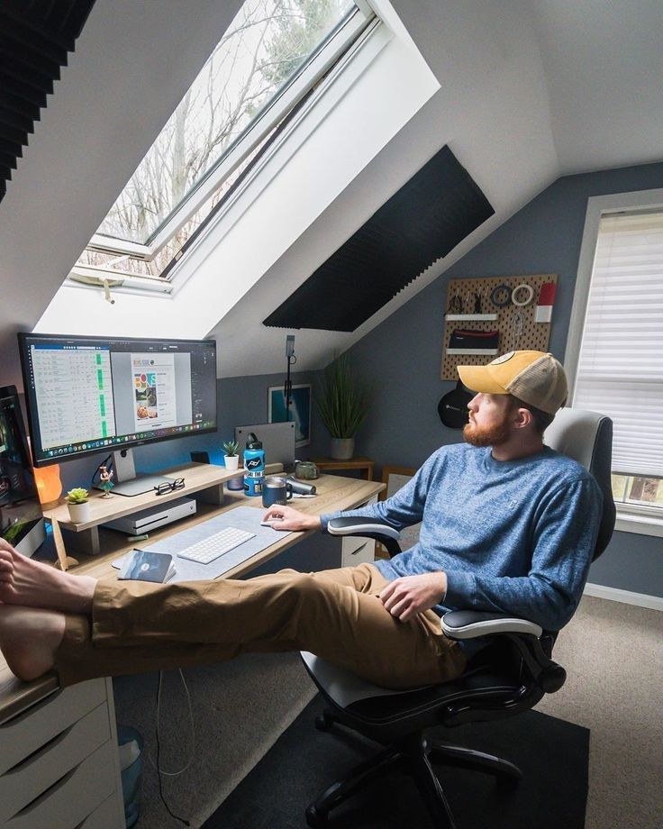 a man wearing a cowboy hat sitting in an office chair with his feet up on the desk