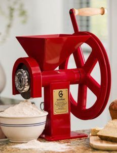 a red machine sitting on top of a counter next to bread