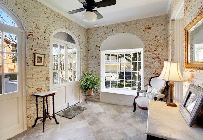 a living room filled with furniture and a ceiling fan