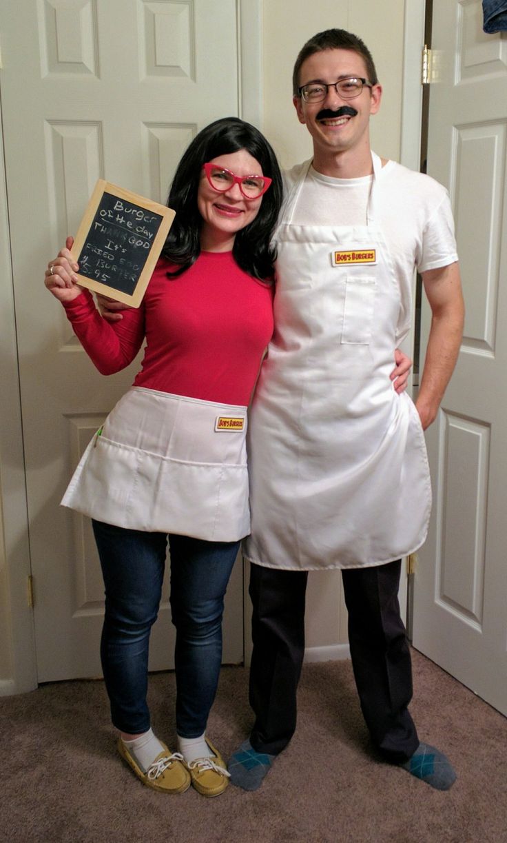 a man and woman dressed up as chefs posing for the camera with a chalkboard in front of them