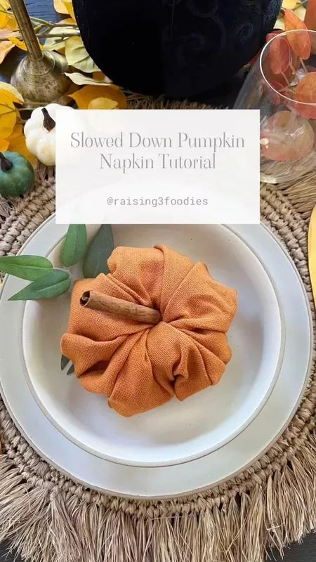 the pumpkin napkin fold is sitting on a plate