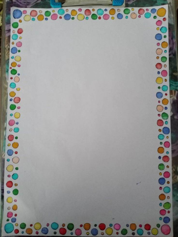 a white board with colorful dots on it and a clipboard attached to the back