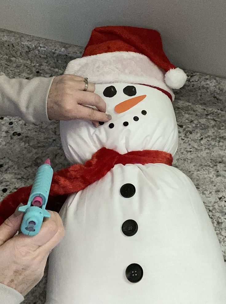 someone is making a snowman out of fabric