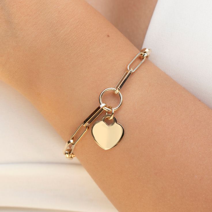 Crafted from genuine solid gold, this bracelet features a chunky heart charm that adds a touch of romance to any ensemble. With the option for personalization, you can engrave it with initials, a special date, or a meaningful message, making it a truly unique and cherished piece.  *Free Express International Shipping *Next business day shipping PRODUCT DETAILS *The product is made of 100% 14k Solid Gold  *       It has a 14K or 585 stamp on item. (We don't sell filled or plated jewelry) *The pac Gold Bracelets With Heart Pendant Charms, Everyday Yellow Gold Heart Charm Bracelet, Valentine's Day Gold Charm Bracelet With Heart Charm, Yellow Gold Charm Bracelet With Heart For Anniversary, Heart-shaped Gold Bracelet With Charms For Valentine's Day, Gold Bracelets With Heart Pendant And Lobster Clasp, Gold Heart Pendant Bracelet With Lobster Clasp, Valentine's Day Yellow Gold Bracelets With Charms, Valentine's Day Heart-shaped Gold Bracelet With Charms