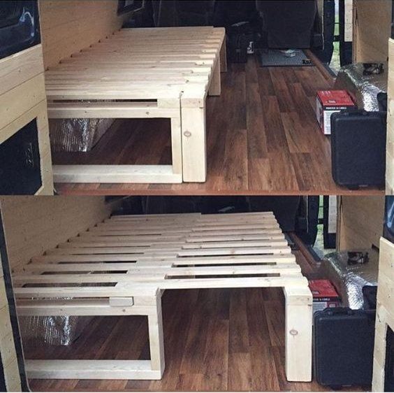 the inside of a camper van with wood flooring and storage compartments on each side