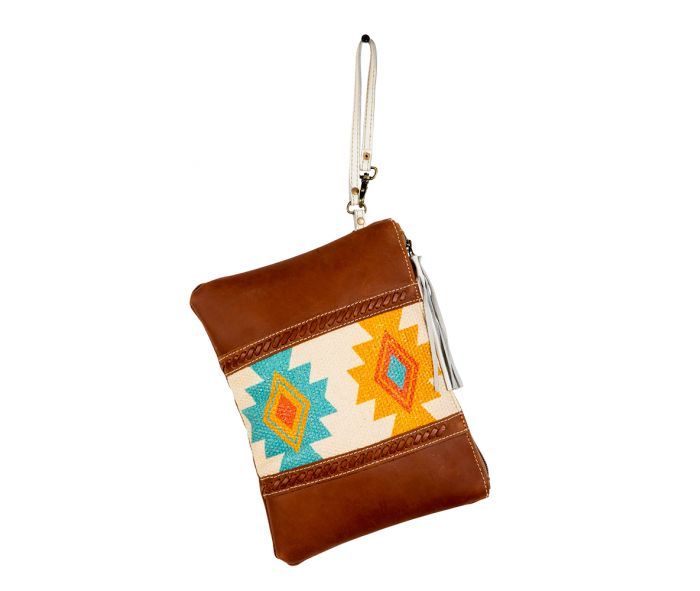 A delightful Southwest- and tribal-inspired design, in gorgeous colors, is the showpiece of this stunning bag. Tones of golden yellow, red and turquoise fill the upcycled woven rug, while panels of aged leather in warm cognac brown feature cross-stitched accents. Simply beautiful. The back is woven canvas in matching cognac brown. Zipper-close top with white leather wristlet carrying strap. Traditional Brown Pouch For Everyday Use, Brown Woven Travel Pouch, Travel Woven Brown Pouch, Travel Brown Woven Pouch, Traditional Brown Rectangular Pouch, Bohemian Handmade Brown Pouch, Handmade Bohemian Brown Pouch, Bohemian Brown Rectangular Wallet, Brown Leather Handle Pouch