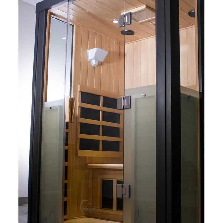 the inside of a sauna with glass doors