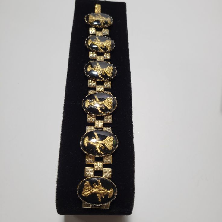 "This is a classic 50s Thermoset and book-chain link bracelet. It features six large 1\" elongated Lucite oval panels which showcase an oriental Empress in gold-tone inside. Each panel has four decorative gold-tone metal squares attached to the back and each panel is joined together by a book chain link. The bracelet is 7 1/4\" long and 1\" wide and it is in very good vintage condition. This is a vey pretty and a UNIQUE vintage look that you won't see very often. This will make a great vintage a Vintage Chain, Price Book, Glass Bracelet, Hand Painted Porcelain, Silver Filigree, Vintage Bracelets, 1960s Vintage, Chain Link Bracelet, Gold Tone Metal