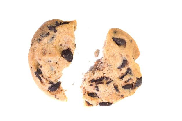 two chocolate chip cookies split in half on a white background