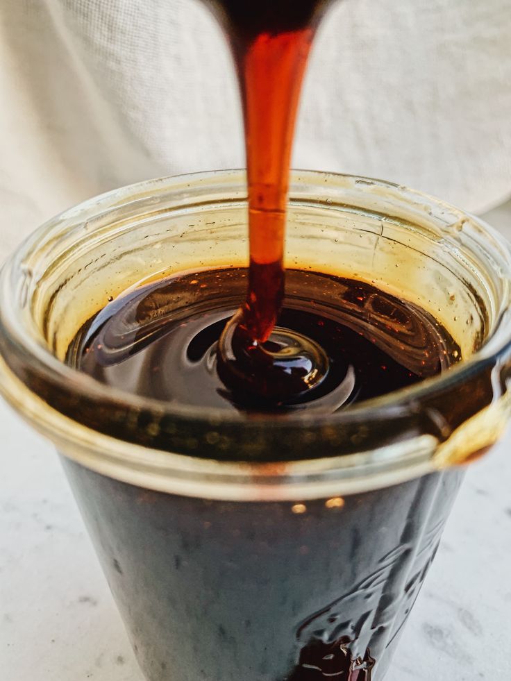 a jar filled with liquid sitting on top of a table